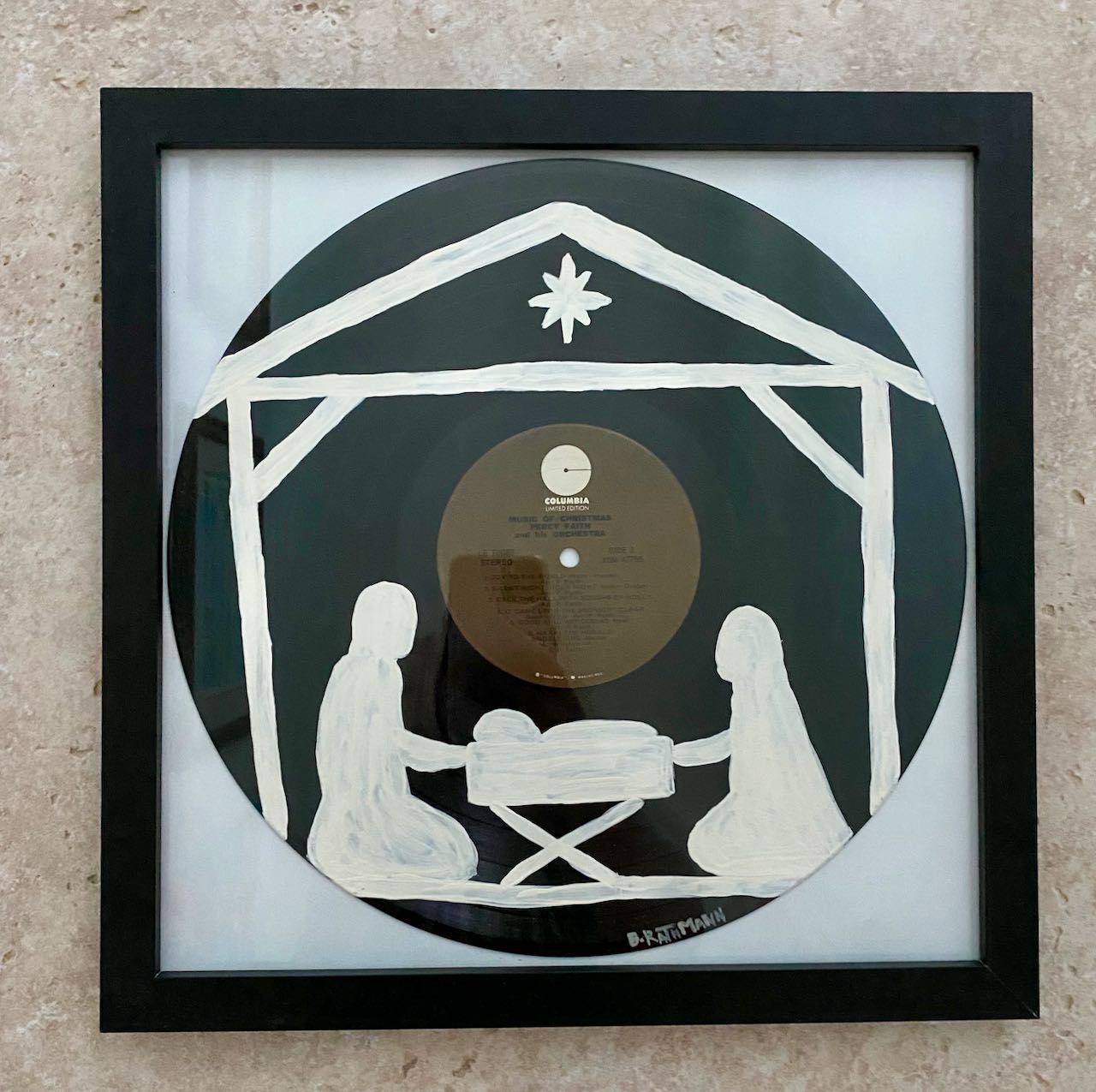 Music of Christmas Record is an acrylic painting of the Wonderful Holy Night of the birth of Jesus! This original painting is perfect for any space. This work was done on a repurposed vinyl record bought at a local thrift store. This was inspired by the music listed on the vinyl album. The frame is included with purchase.