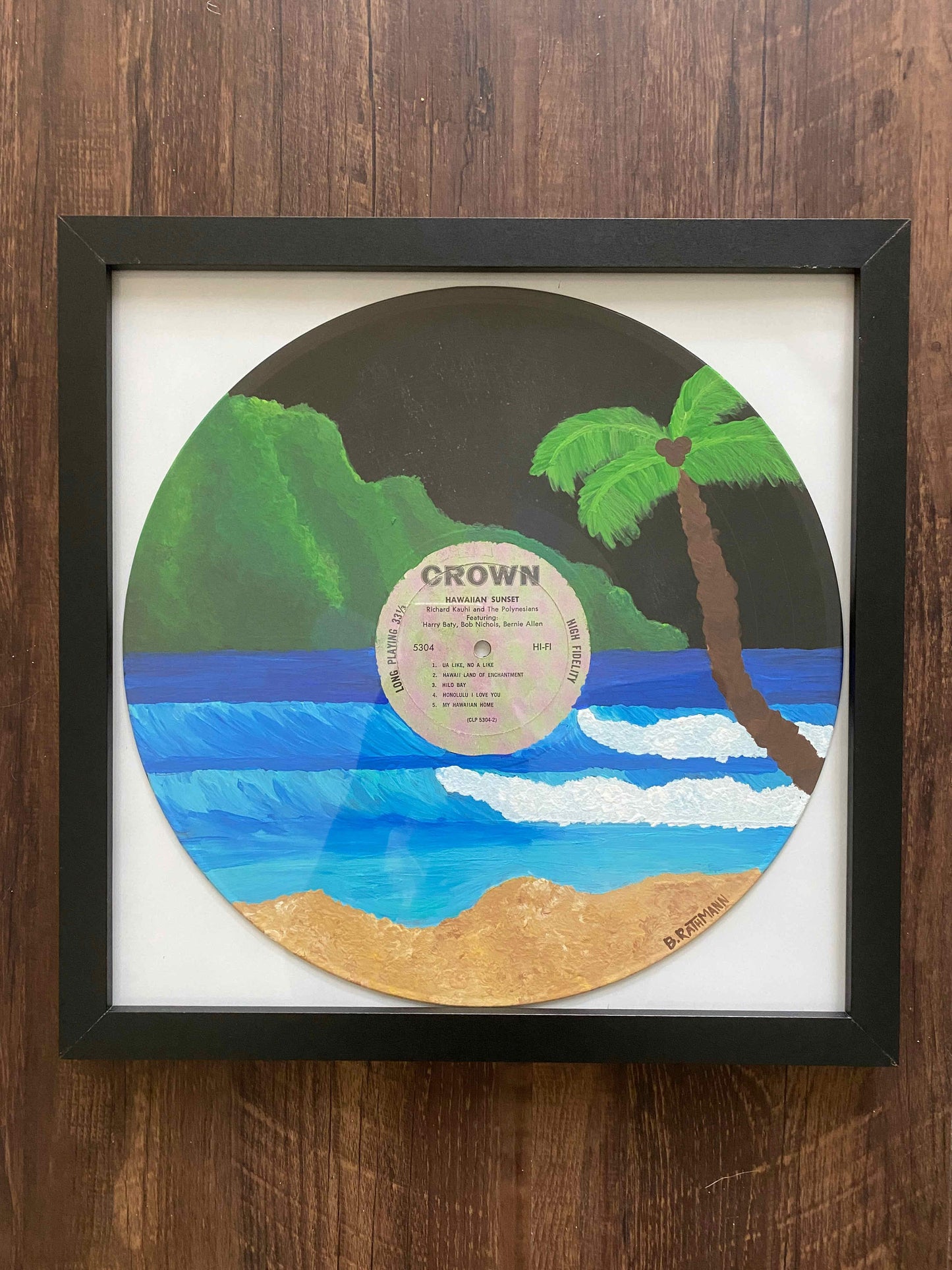 Hawaiian Sunset Record is an acrylic painting of a Hawaiian island on a thrifted record. This original painting is perfect for any space. This work was done on a repurposed vinyl record bought at a local thrift store.