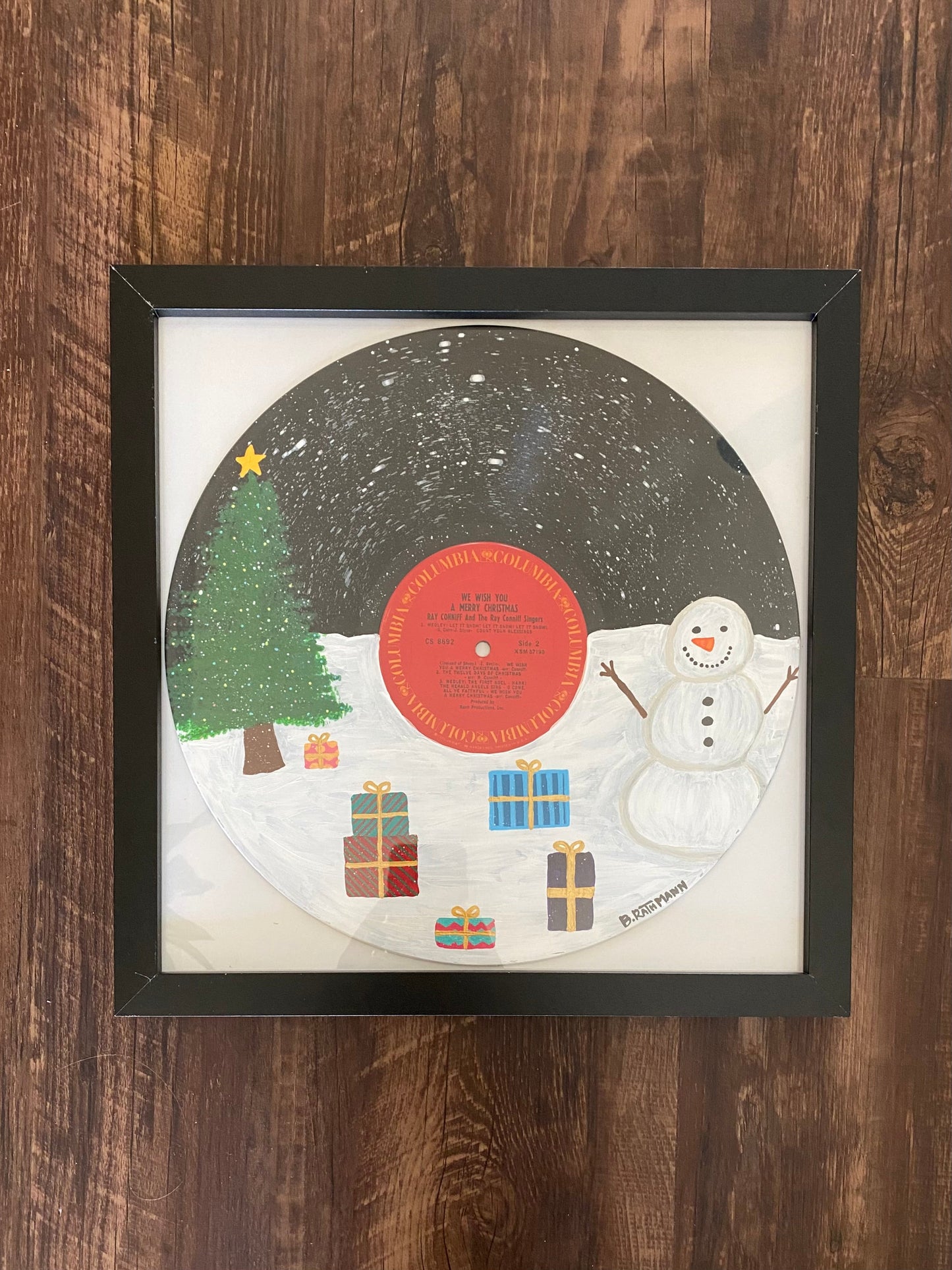 We Wish You a Merry Christmas  Record is an acrylic painting of a dreamy winter wonderland with a snowman and a Christmas tree! This original painting is perfect for any space. This work was done on a repurposed vinyl record bought at a local thrift store. This was inspired by the music listed on the vinyl album. The frame is included with purchase.
