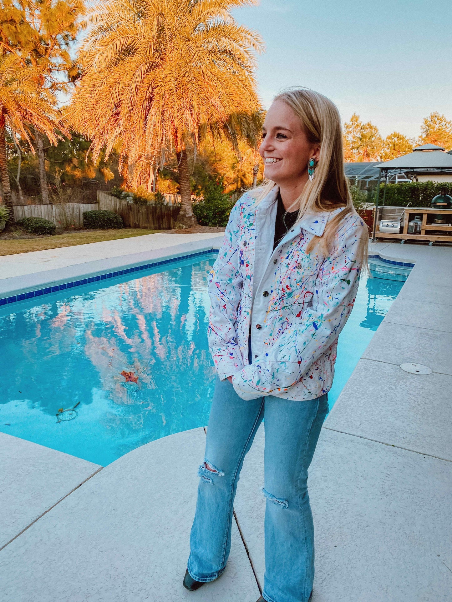This is a custom splatter paint denim jacket  that has been custom splattered painted with rainbow colors. This is a custom painted jean jacket.