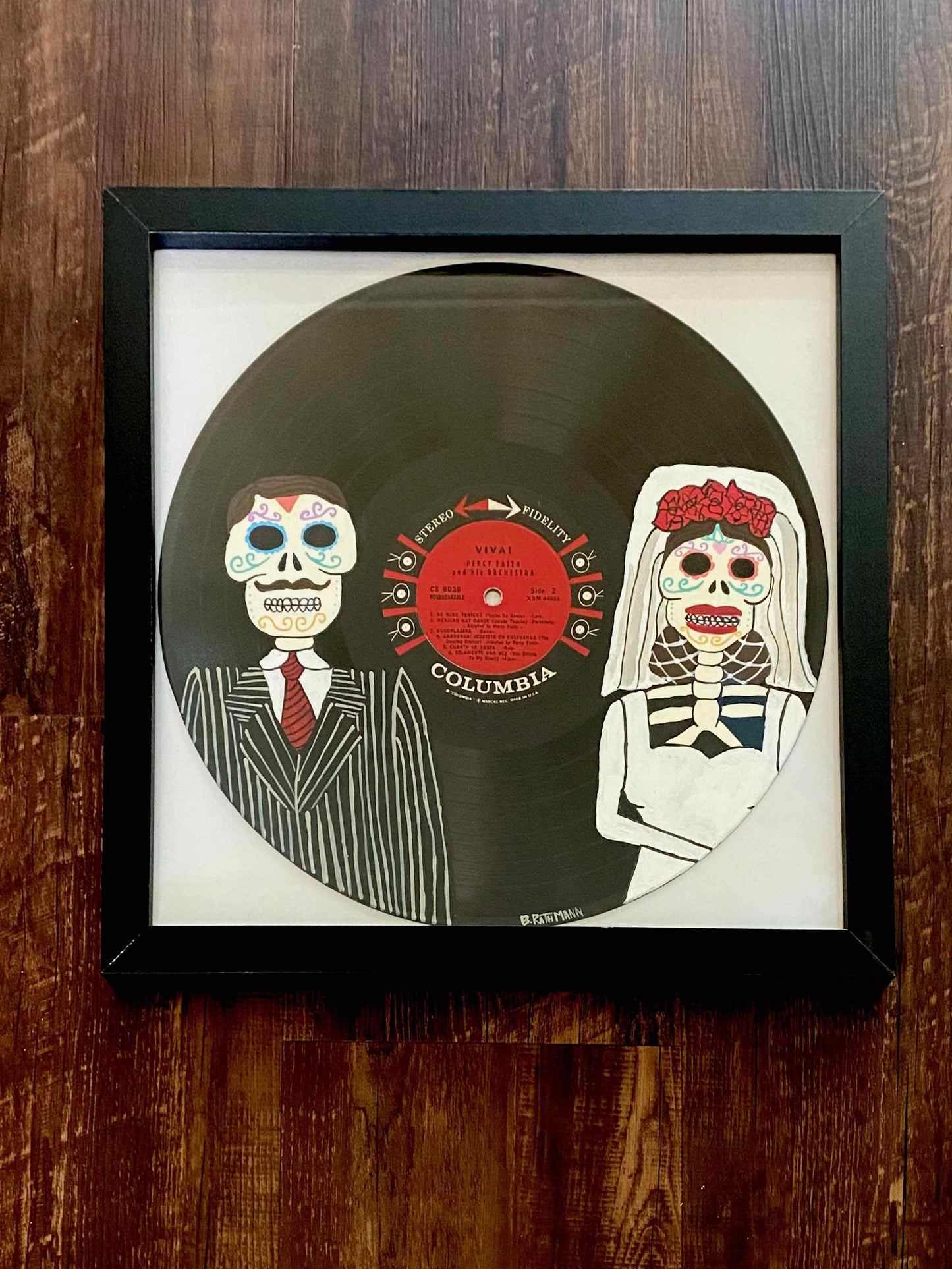 Viva Record is an acrylic painting of a traditional Dia de los Muertos couple to honor the cultural traditions of Mexico.